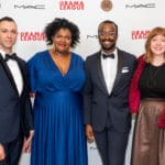 Four Drama League directors standing in front of a drama league step and repeat