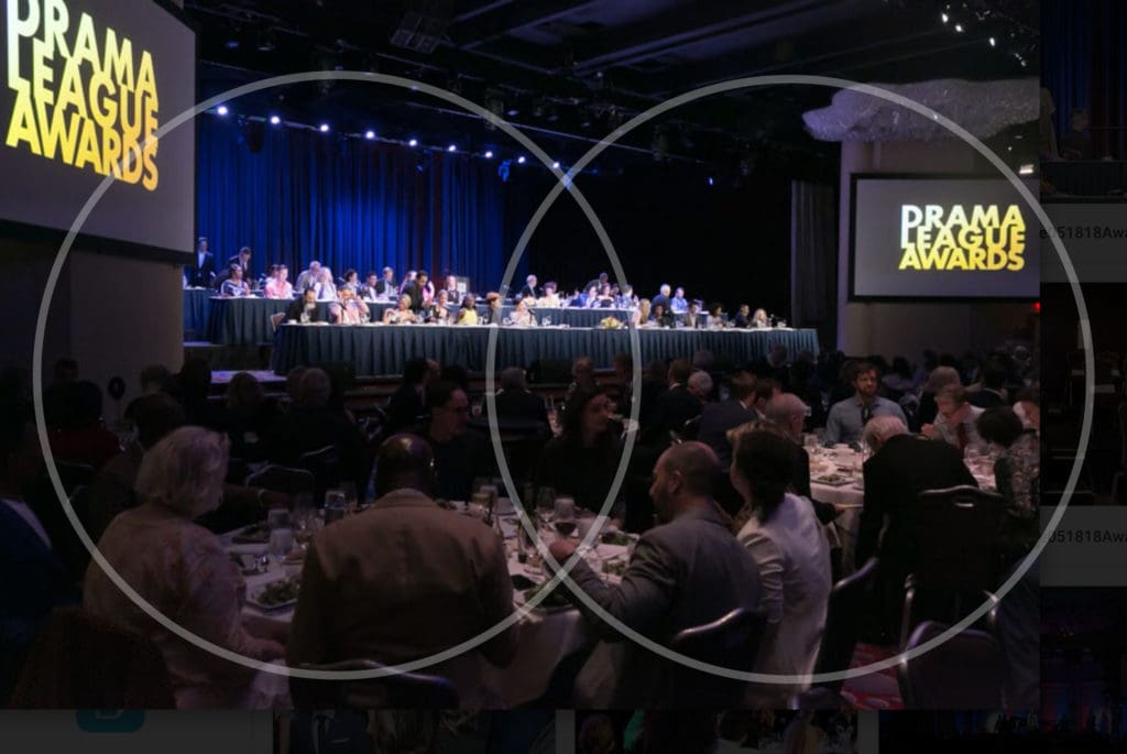 Wide shot of Drama League Awards event, two screens show graphic for Drama League Awards